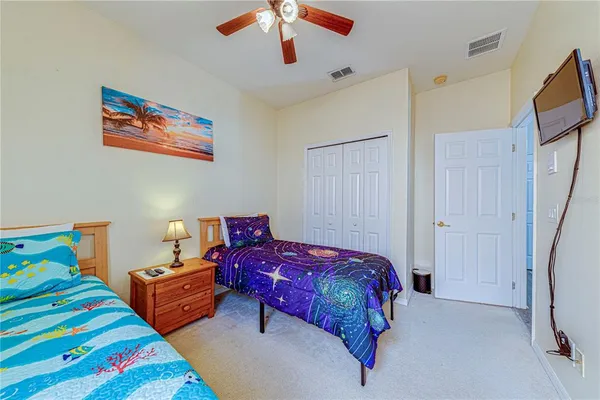 a bedroom with bed and a chandelier