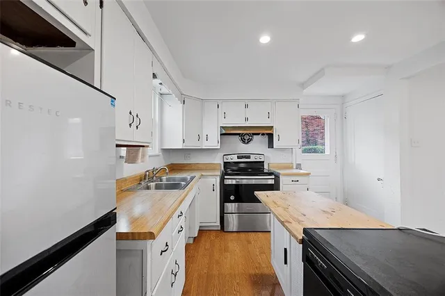 a kitchen with a stove and a refrigerator