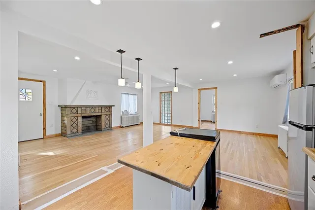 a view of a kitchen with a sink and a fireplace
