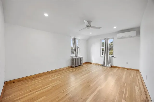 a view of an empty room with closet and a window