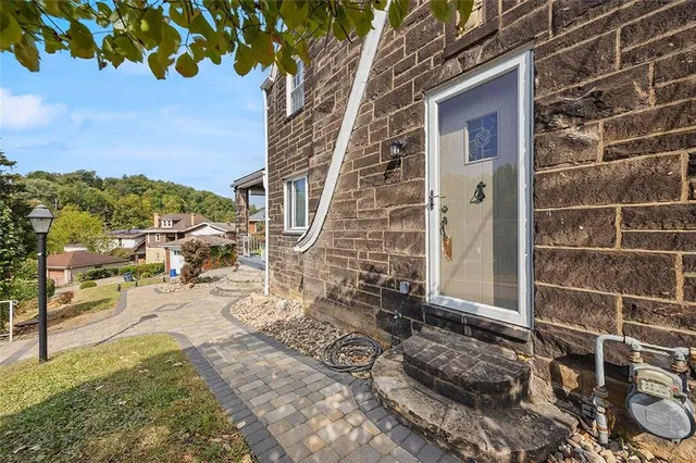 a view of a brick house with a yard