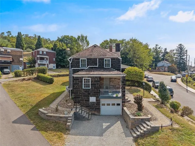 a view of a house with a yard balcony and sitting area