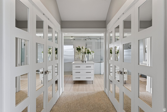 12308 Mariah Circle Draper, UT 84020 - Photo 67 of 293 Primary Suite Hallway with dual mirrored closet doors, light wood-finish flooring, and a contemporary white dresser