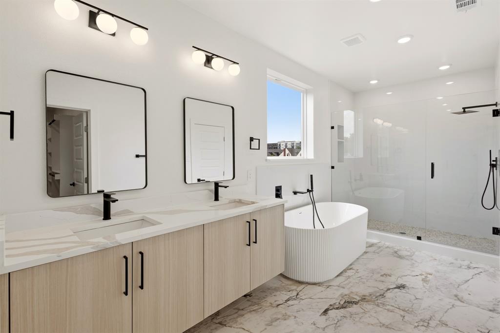 415 North Patton Avenue Dallas, TX 75203 - Photo 9 of 20 Bathroom featuring a double vanity with light wood cabinetry, a freestanding bathtub, and a glass-enclosed shower