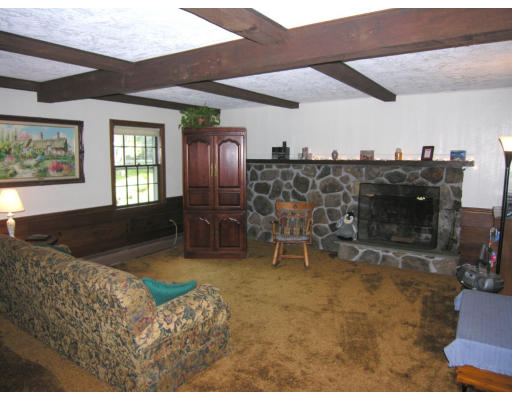 419 Border Road Concord, MA 01742 - Photo 3 of 13 a living room with furniture a flat screen tv and a fireplace