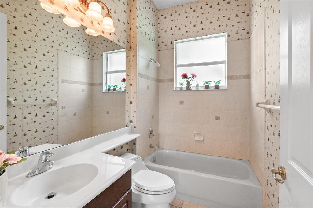 3462 Dovecote Meadow Lane Davie, FL 33328 - Photo 12 of 40 a bathroom with a bathtub a sink and a large mirror