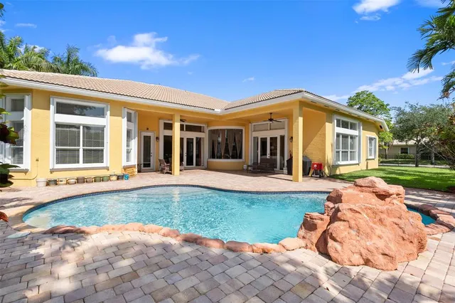 a utility room with cabinets washer and dryer