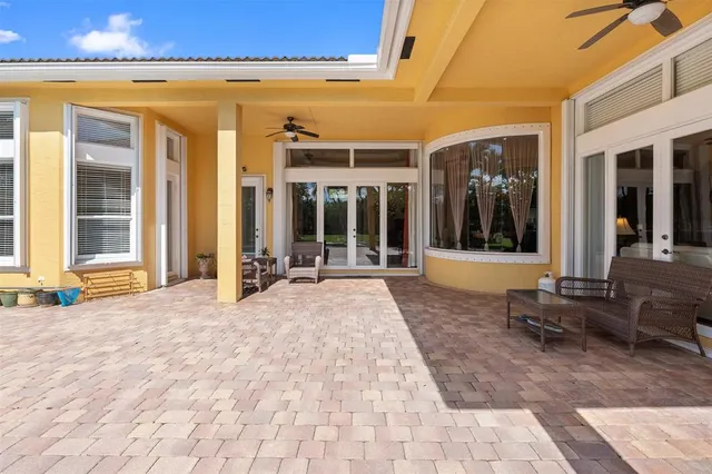 a living room with patio furniture and a flat screen tv