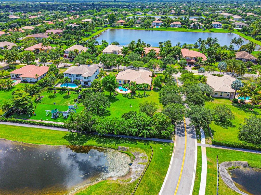 3462 Dovecote Meadow Lane Davie, FL 33328 - Photo 34 of 40 an aerial view of a houses with a garden and lake view