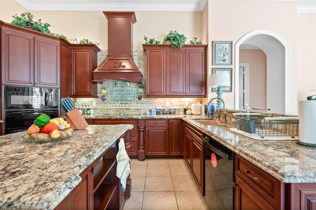 3462 Dovecote Meadow Lane Davie, FL 33328 - Photo 5 of 40 a kitchen with stainless steel appliances granite countertop a sink stove and cabinets