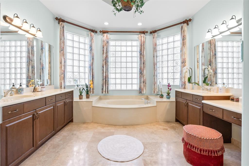 3462 Dovecote Meadow Lane Davie, FL 33328 - Photo 7 of 40 a bathroom with a granite countertop double vanity sink large mirror bathtub and toilet