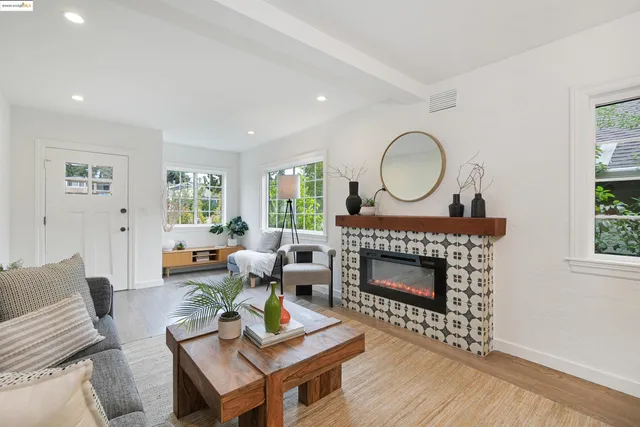 a living room with furniture a fireplace and a window