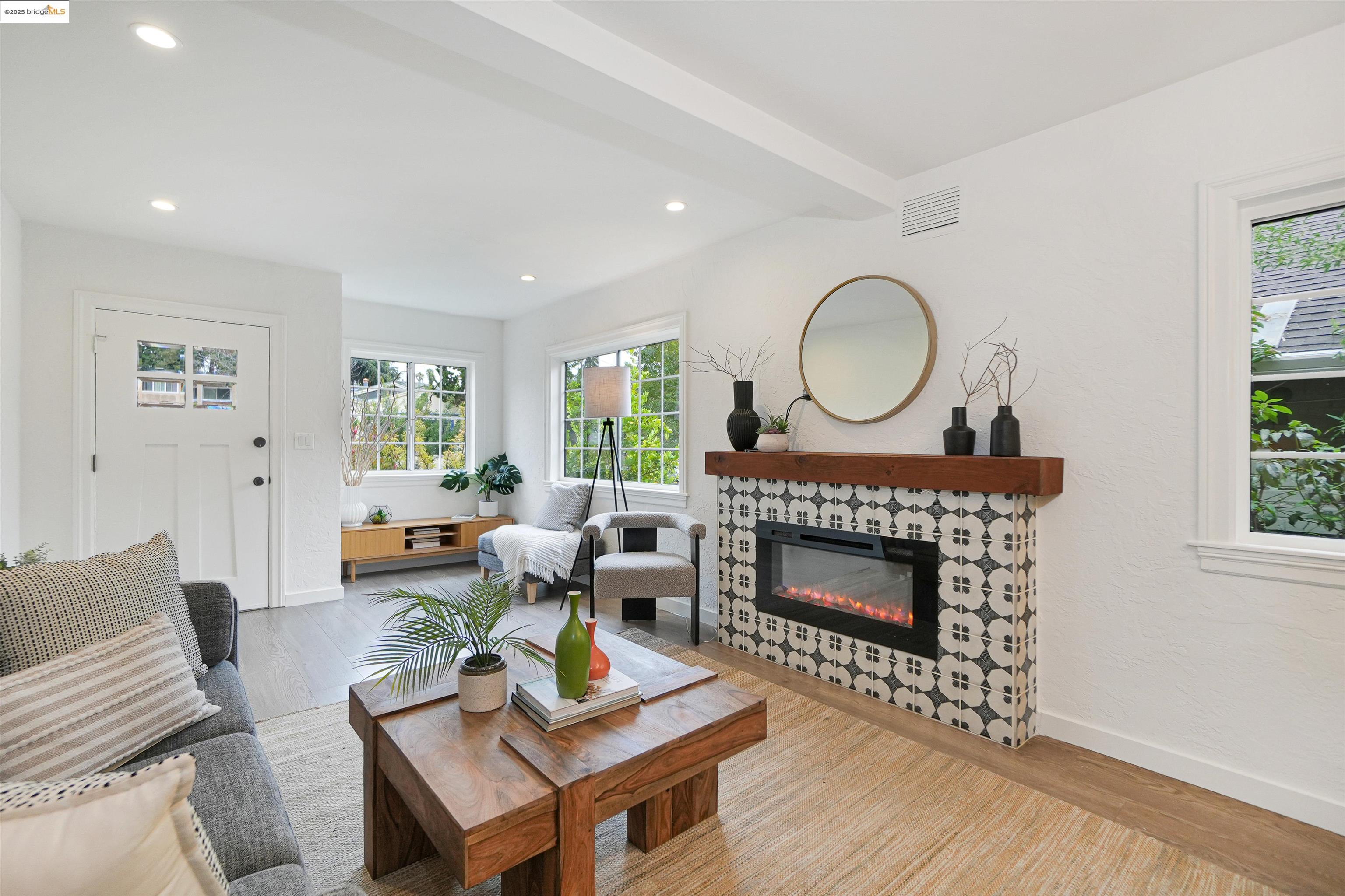 3911 Vale Avenue Oakland, CA 94619 - Photo 16 of 45 a living room with furniture a fireplace and a window