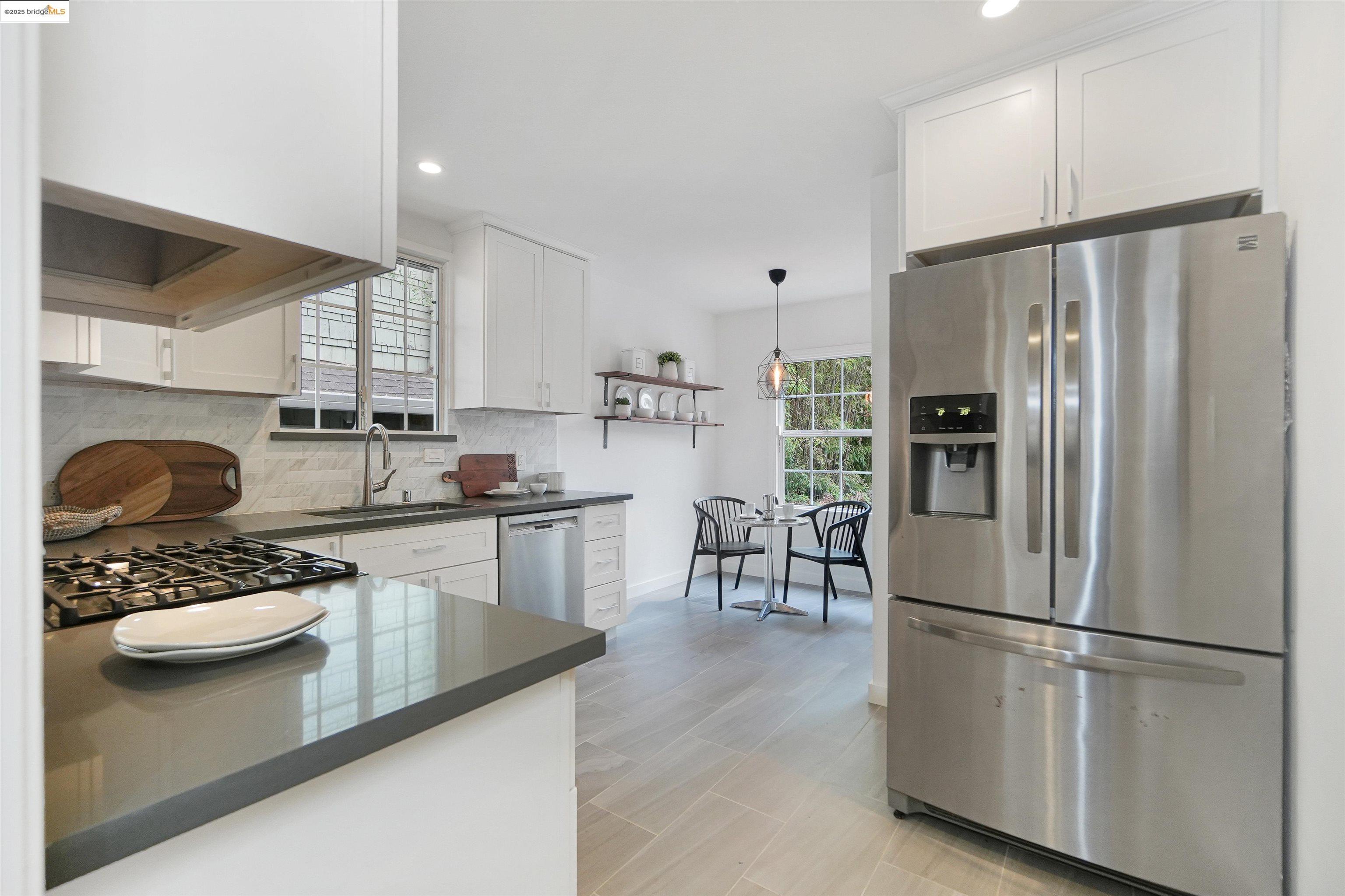 3911 Vale Avenue Oakland, CA 94619 - Photo 21 of 45 a kitchen with stainless steel appliances granite countertop a refrigerator sink and stove