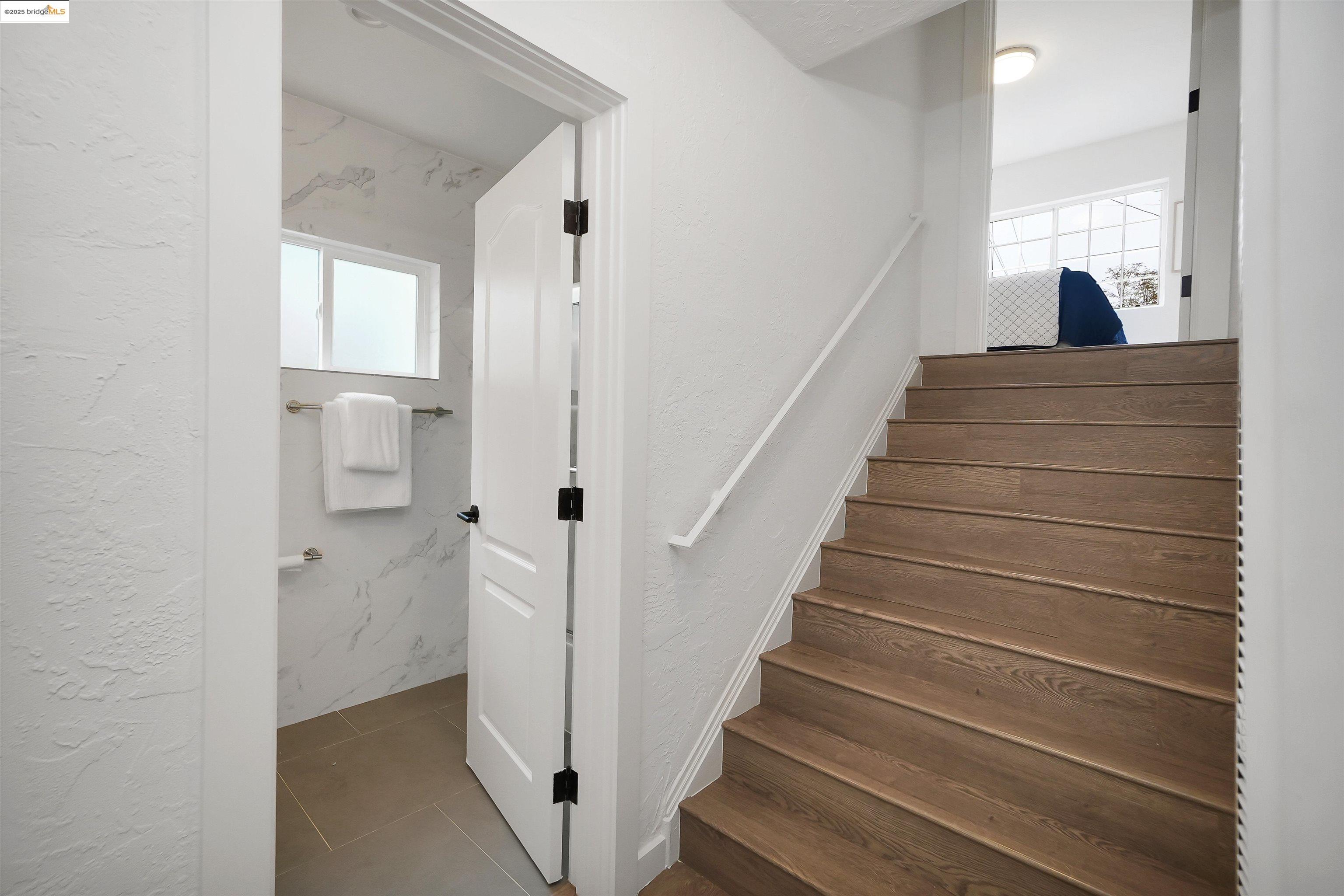 3911 Vale Avenue Oakland, CA 94619 - Photo 24 of 45 a view of staircase with lots of frames on wall and a window