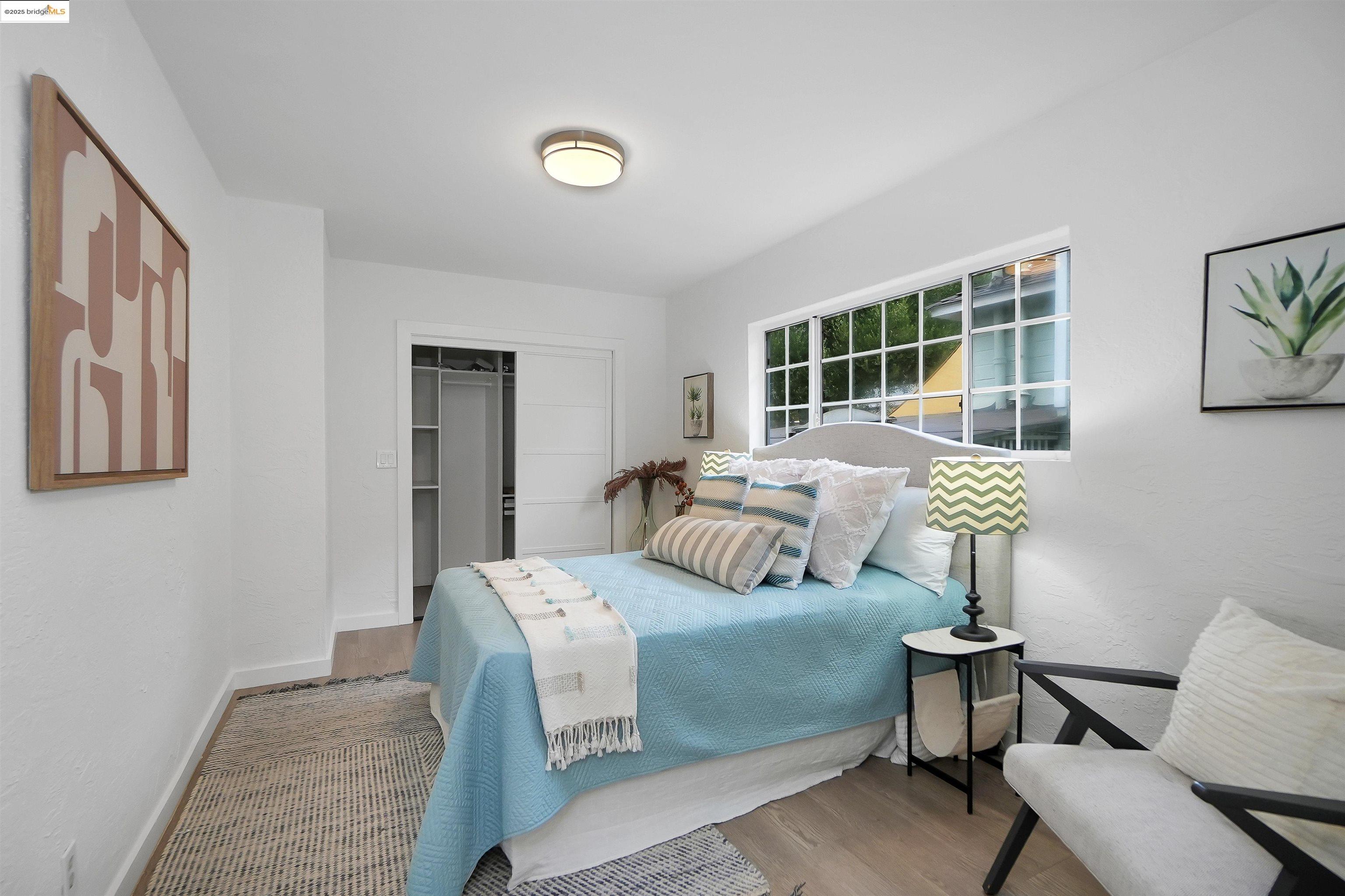 3911 Vale Avenue Oakland, CA 94619 - Photo 25 of 45 a bedroom with a bed and wooden floor