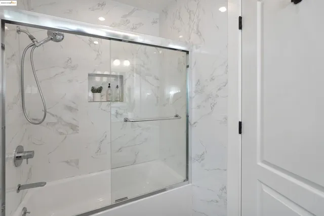a bathroom with a glass shower door