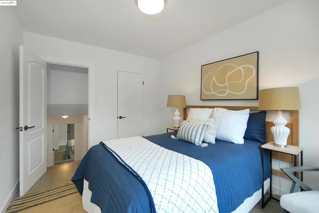 a bedroom with a bed and lamp