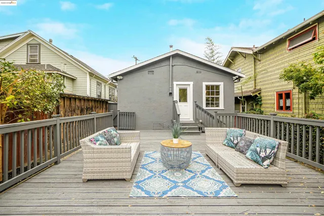 a view of a deck with furniture and a yard