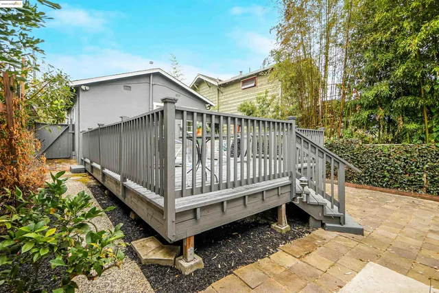 a view of a house with a yard and deck