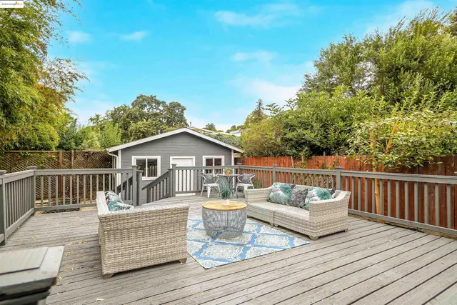 a view of a deck with couches with wooden floor and fence