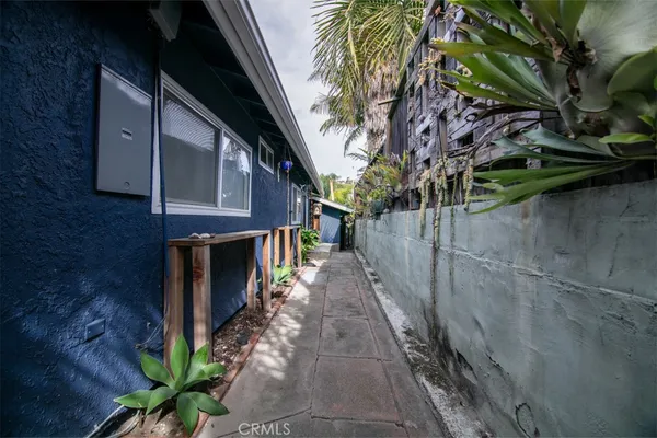 a pathway of a house with a yard