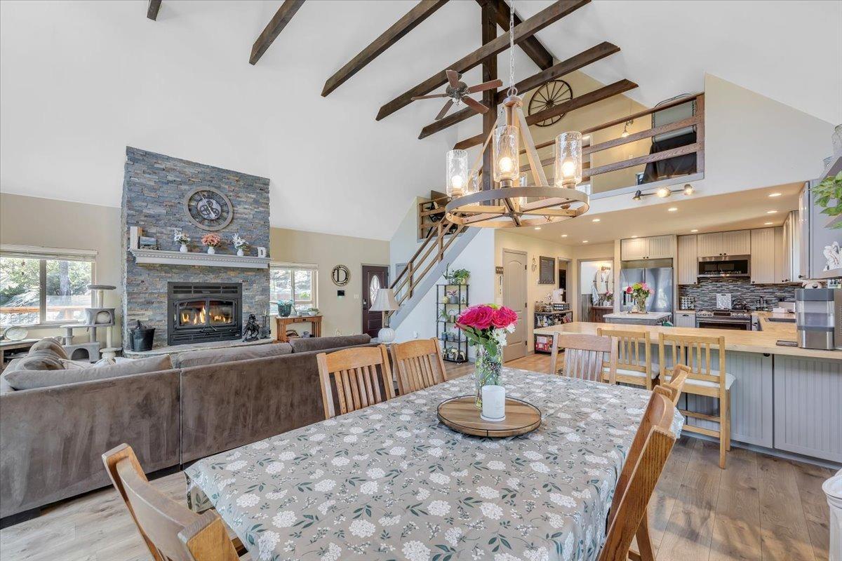 1499 Sawmill Road, Unit 594 Copperopolis, CA 95228 - Photo 22 of 98 a dining room with wooden floor a chandelier a wooden table and chairs