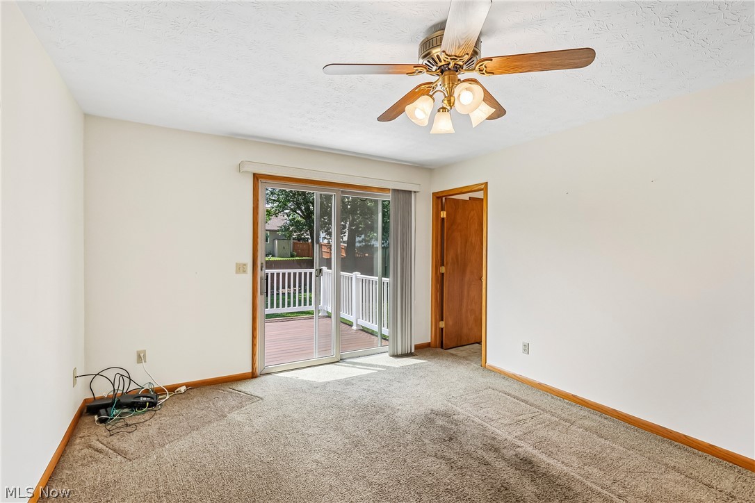 2758 Shellhart Road Norton, OH 44203 - Photo 11 of 41 Family room with ceiling / fan light, slider to deck and carpet flooring