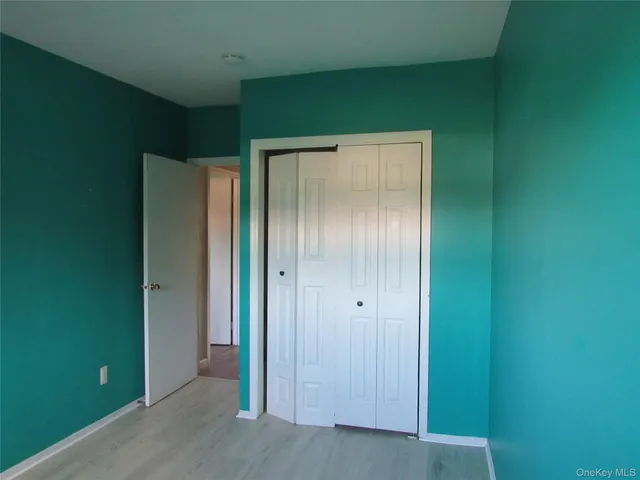 an empty room with closet area