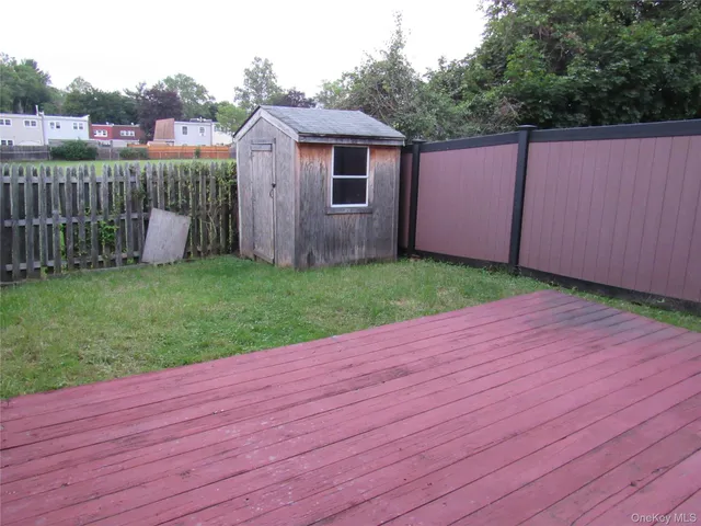 a view of a backyard with wooden fence