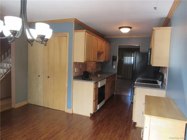 a kitchen with stainless steel appliances granite countertop a refrigerator a stove a sink and a microwave