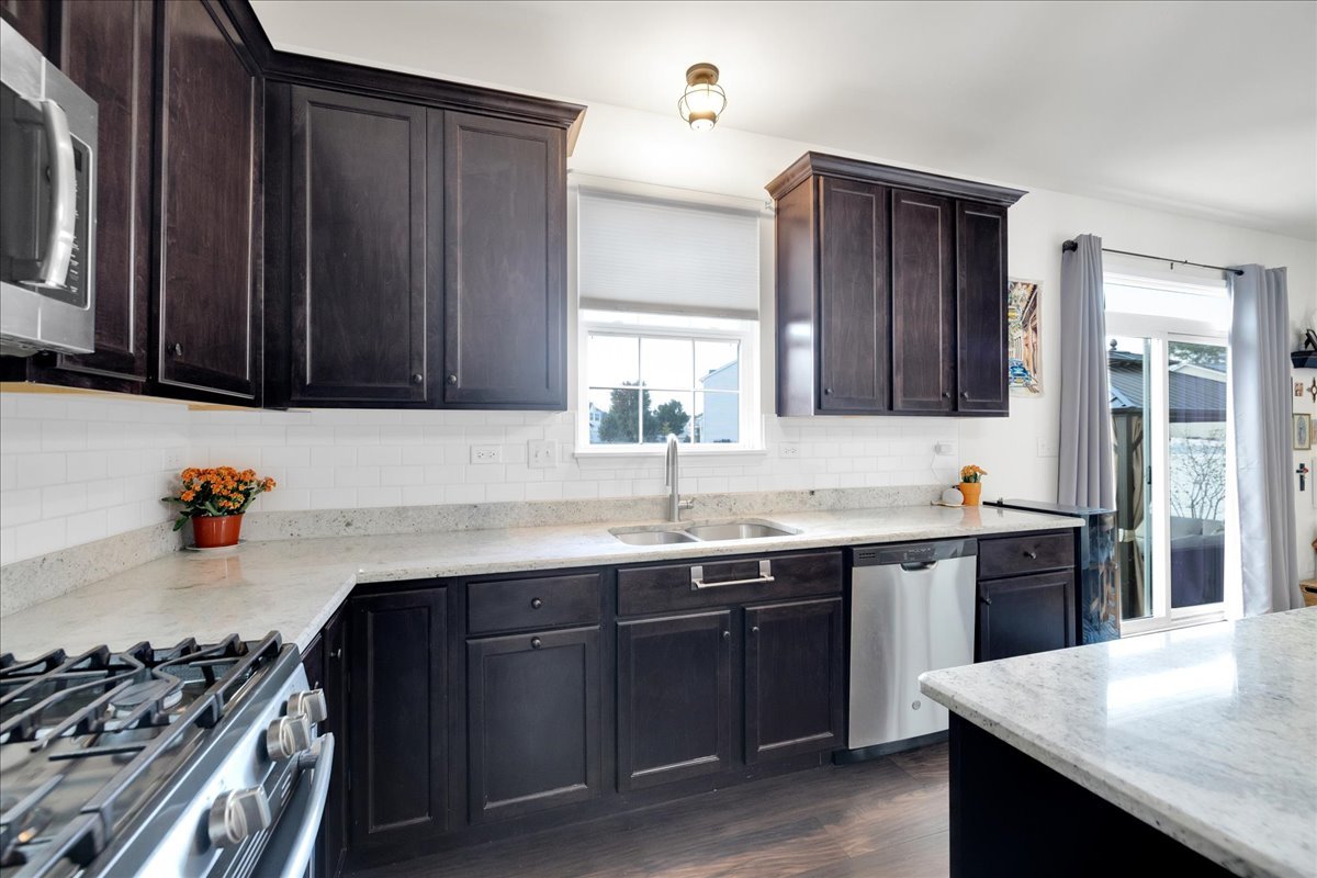 435 Fawn Lane Oswego, IL 60543 - Photo 13 of 47 a kitchen with a sink and a stove
