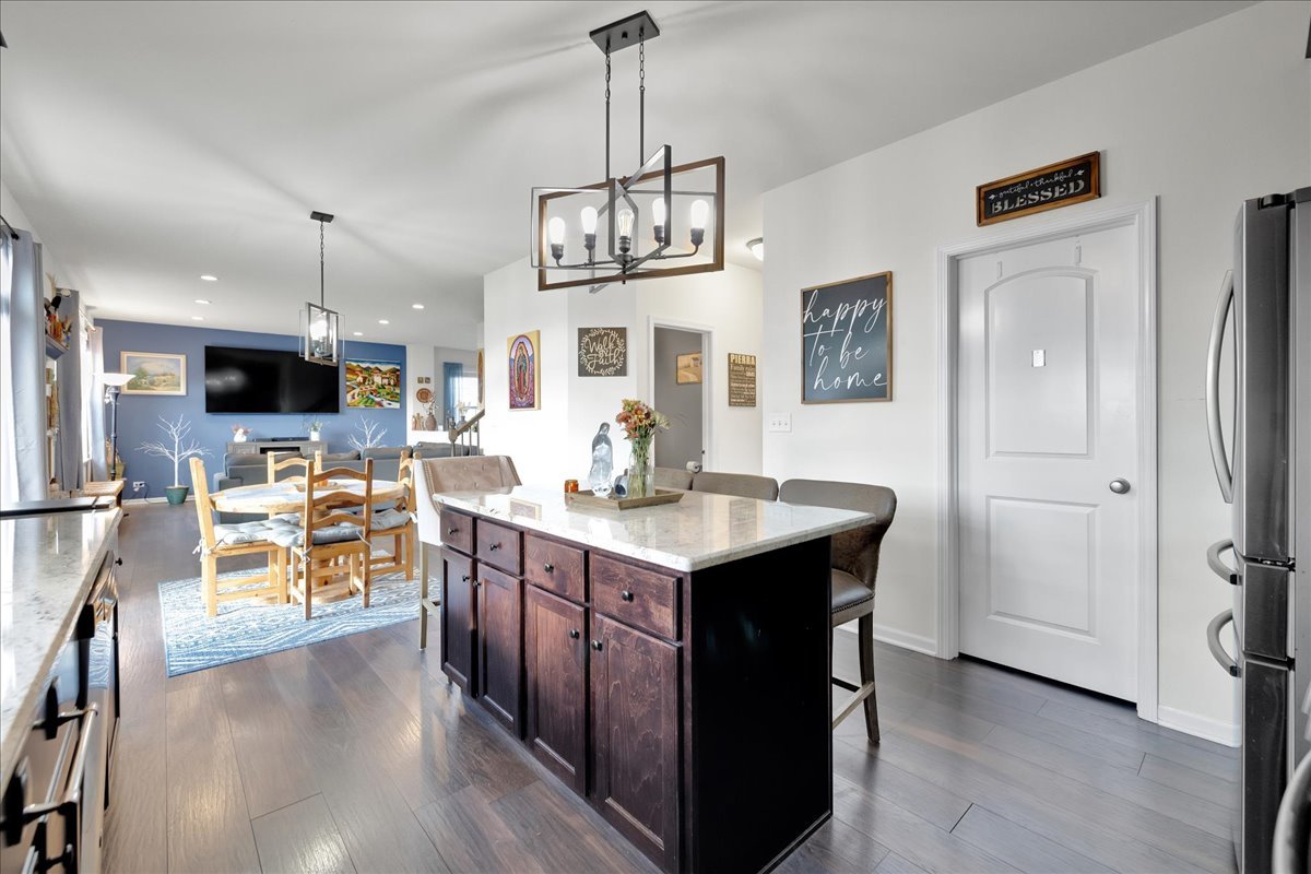 435 Fawn Lane Oswego, IL 60543 - Photo 15 of 47 a kitchen with stainless steel appliances granite countertop a sink stove and refrigerator