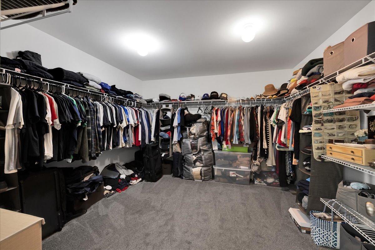 435 Fawn Lane Oswego, IL 60543 - Photo 25 of 47 a view of walk in closet with clothes and shoes