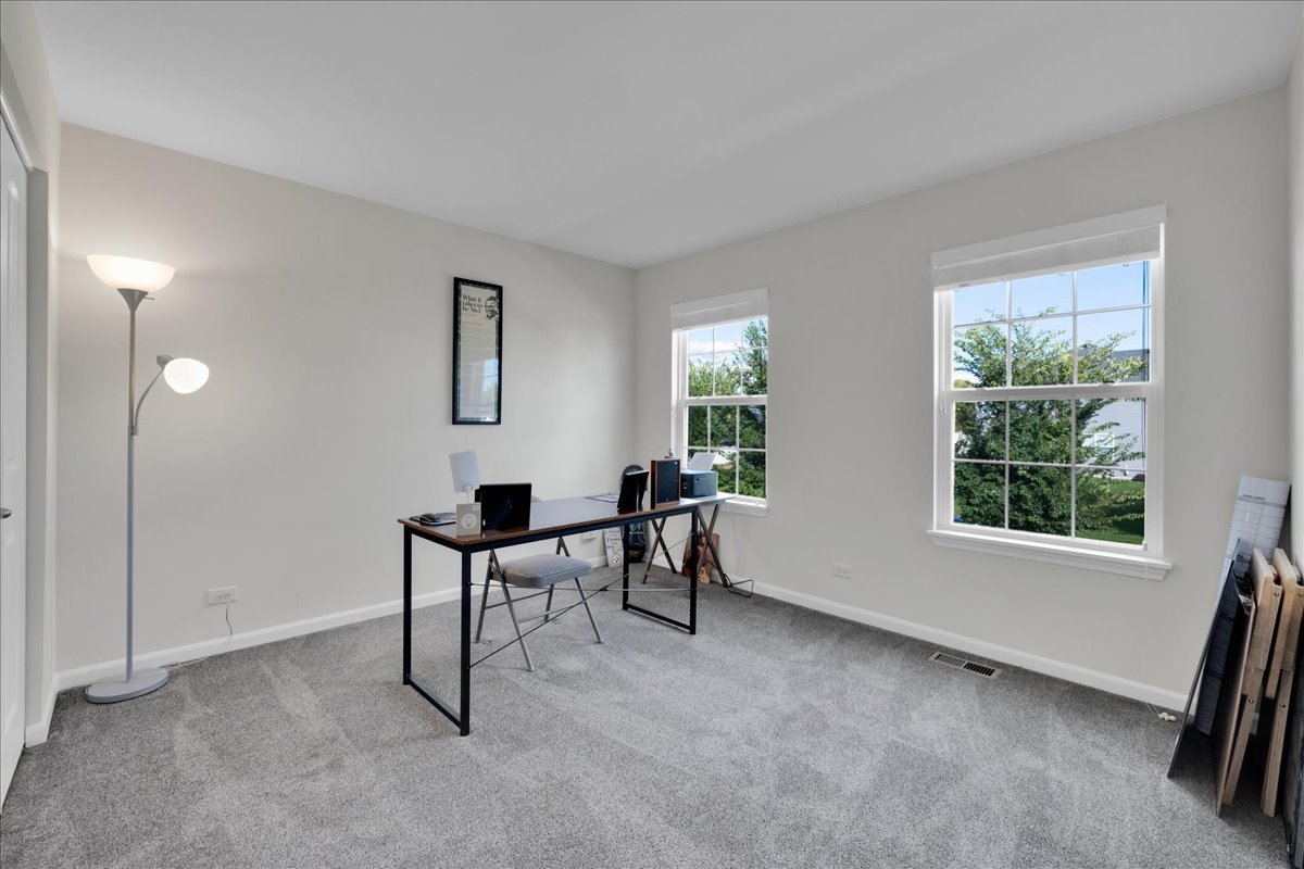 435 Fawn Lane Oswego, IL 60543 - Photo 29 of 47 a view of a workspace with furniture and a window