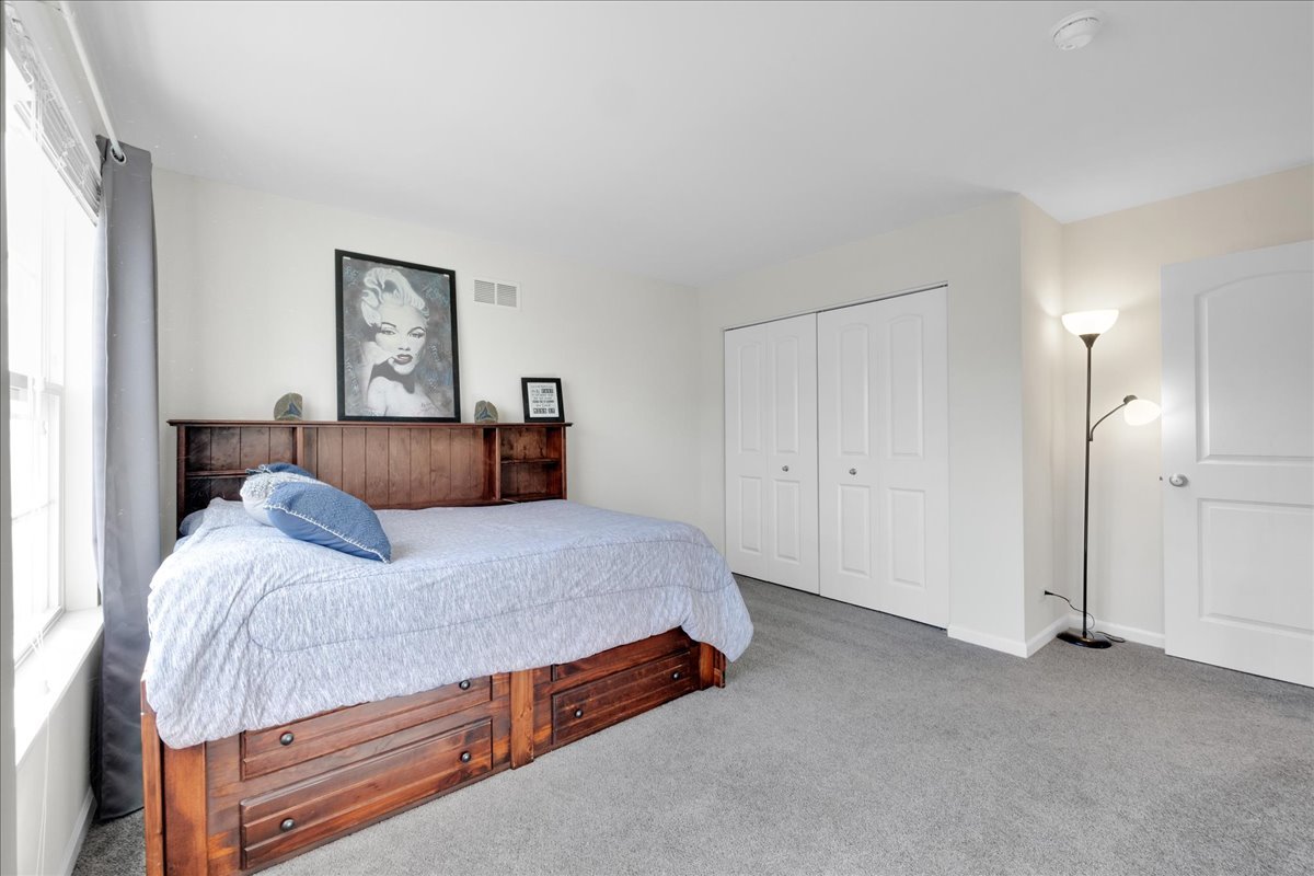 435 Fawn Lane Oswego, IL 60543 - Photo 33 of 47 a bedroom with a bed and painting on the wall