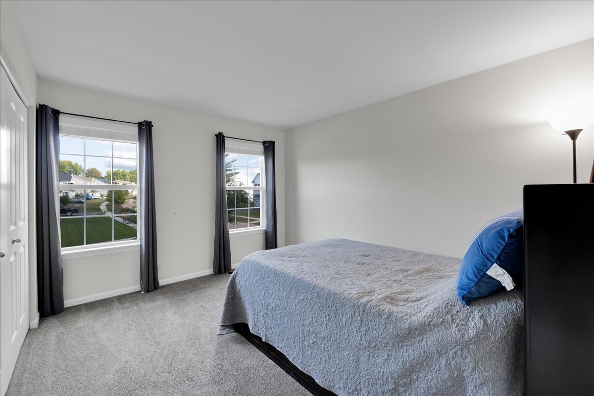 435 Fawn Lane Oswego, IL 60543 - Photo 34 of 47 a bed sitting in a room next to a window