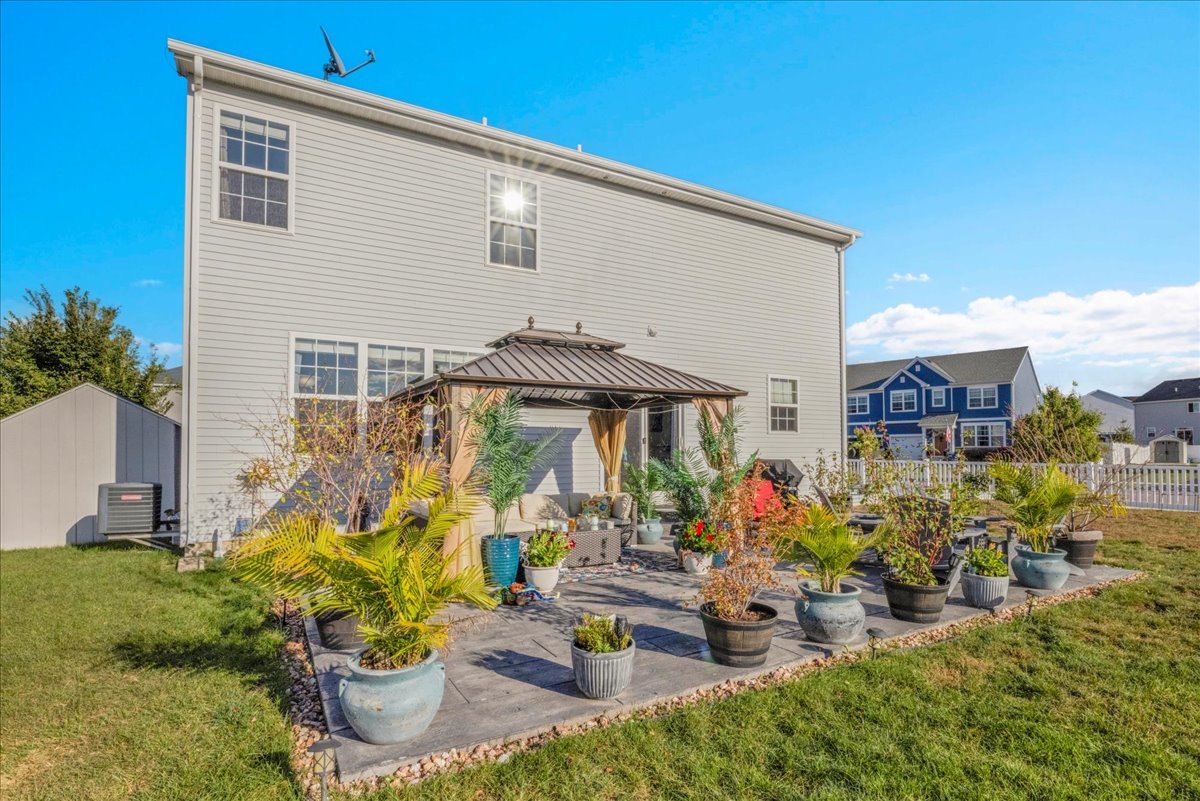 435 Fawn Lane Oswego, IL 60543 - Photo 45 of 47 a view of a patio with table and chairs potted plants