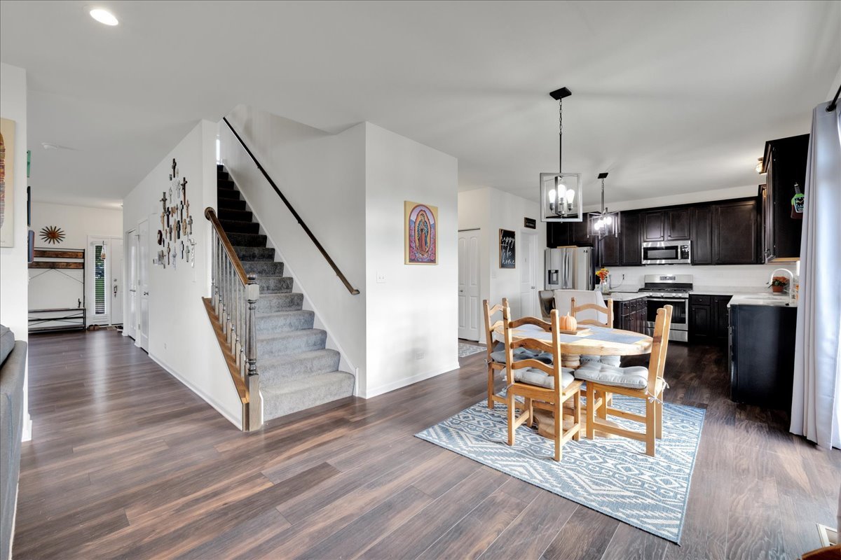 435 Fawn Lane Oswego, IL 60543 - Photo 7 of 47 a living room with furniture and a wooden floor