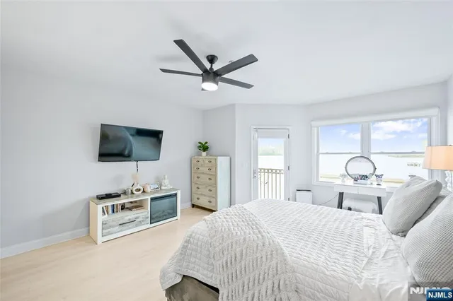 a bedroom with a bed and flat screen tv