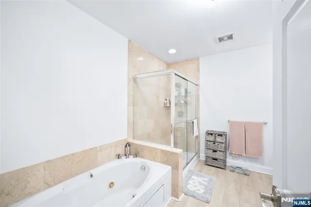 a bathroom with a bathtub and shower