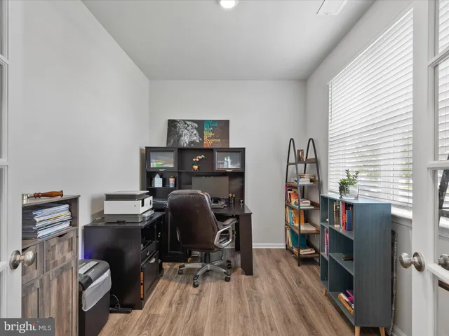 a bedroom with a bed and a lamp next to window
