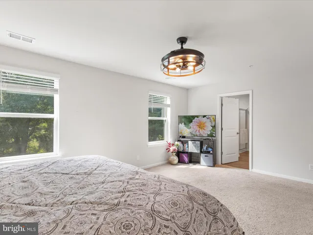 a bedroom with a bed a table and a window