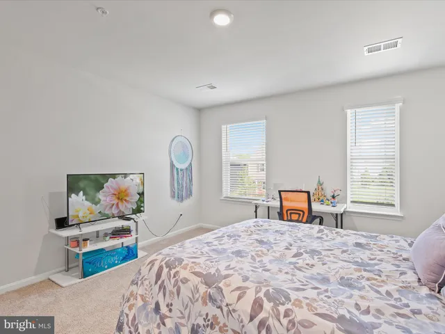 a living room with furniture and a ceiling fan