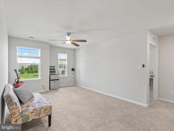 a bedroom with a large bed and a night stand