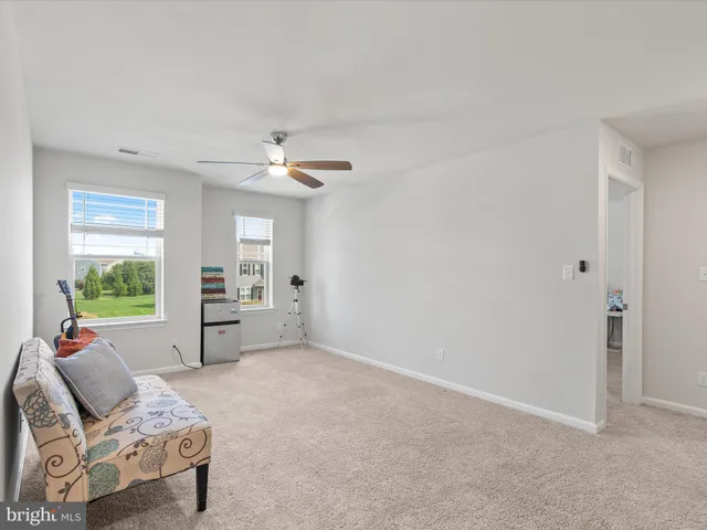 a bedroom with a large bed and a night stand