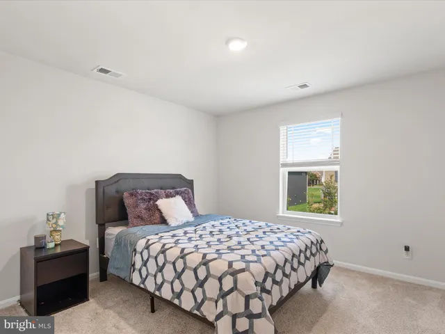 a view of a swimming pool with a bench and trees around