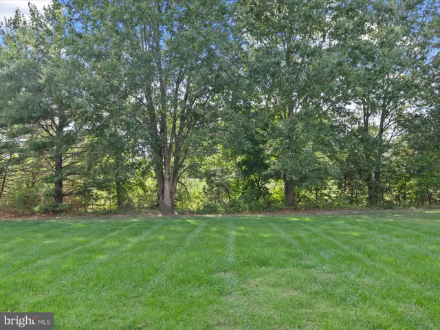 a kitchen with stainless steel appliances a dining table chairs stove and white cabinets