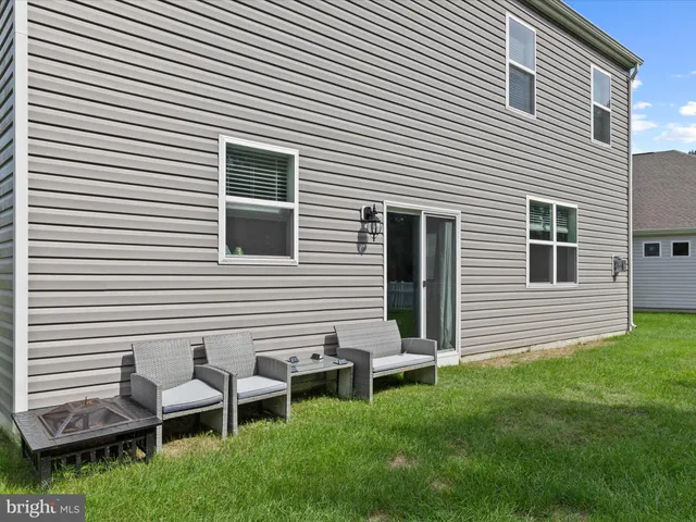 a living room with furniture rug and window