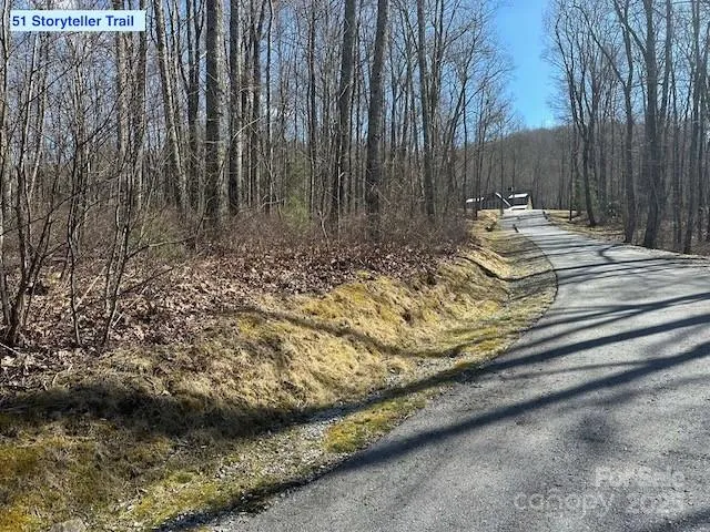 a view of wooden fence and trees